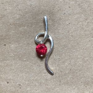 5/$25 Faux pendant: pinkish/red stone in silver colored setting.